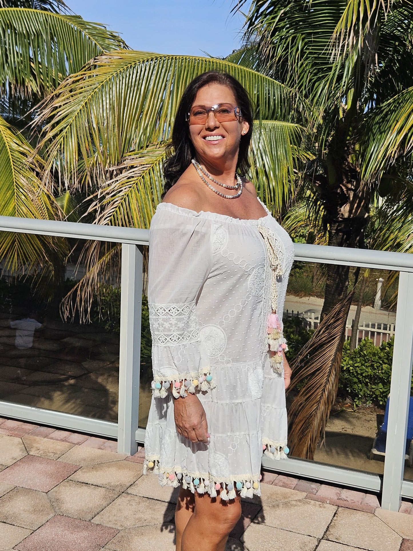 Perfect white summer dress with rainbow pom poms