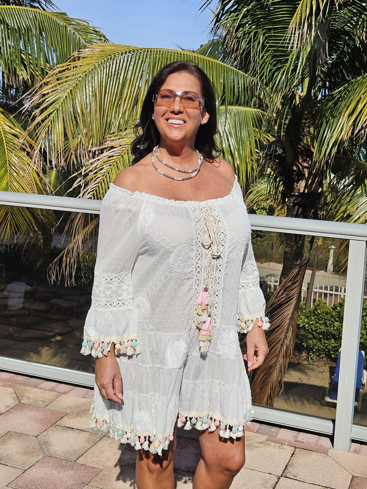 Perfect white summer dress with rainbow pom poms