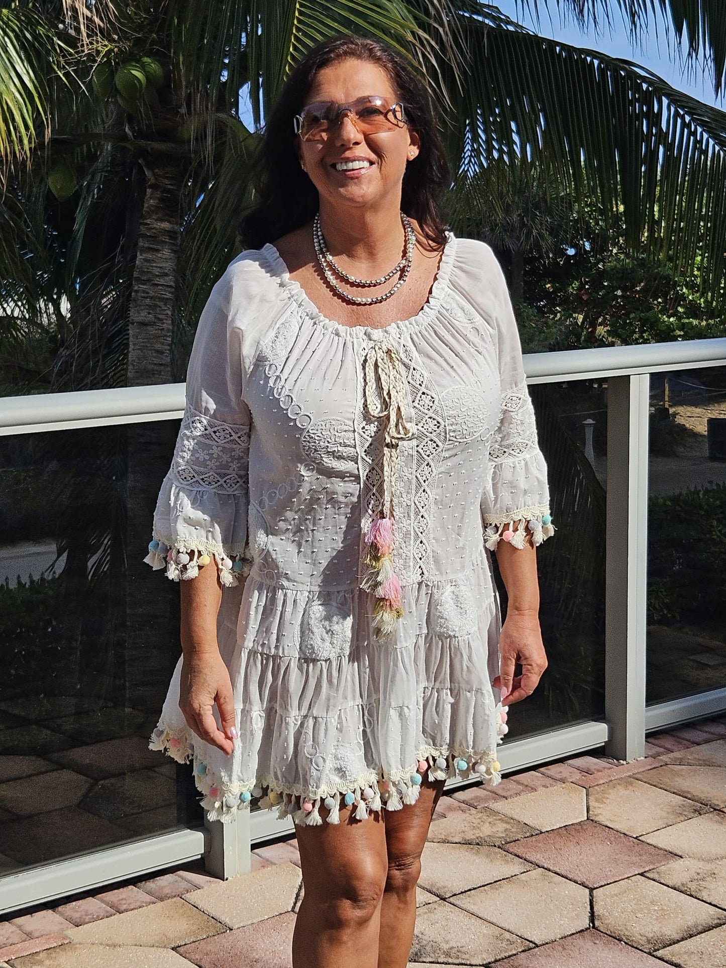 Perfect white summer dress with rainbow pom poms